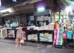 Wholesale flannel in pink, blue, green, yellow and white, at this counter at the intersection of Sampeng Lane and Maha Chak Road.